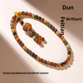 Dunhuang style bodhi seed double ring bracelet with detailed carving on an adjustable cord.