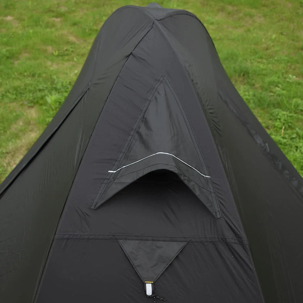 A single person hiking tent with aluminium poles, shown in a black colour option, packed to show its compact size.