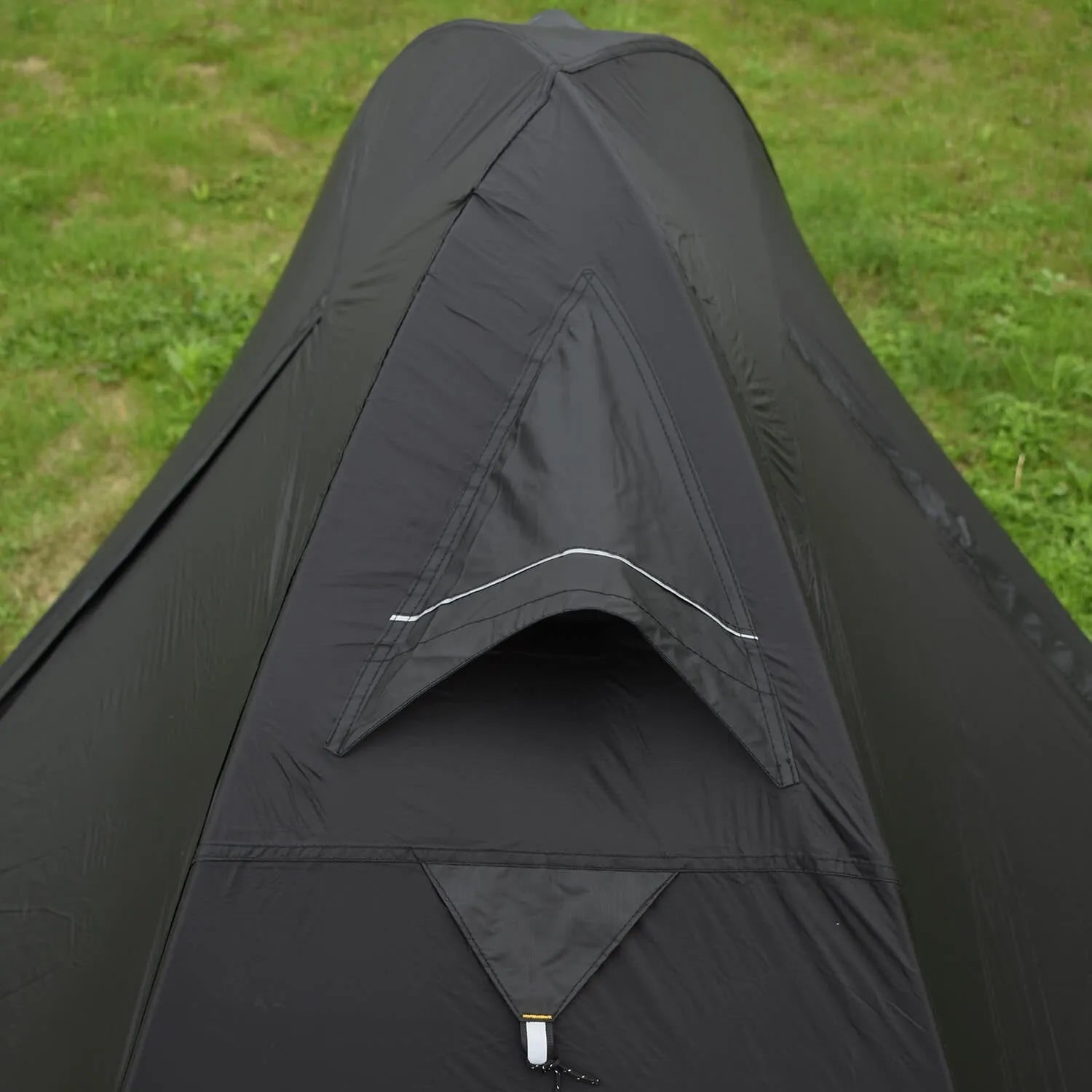 A single person hiking tent with aluminium poles, shown in a black colour option, packed to show its compact size.
