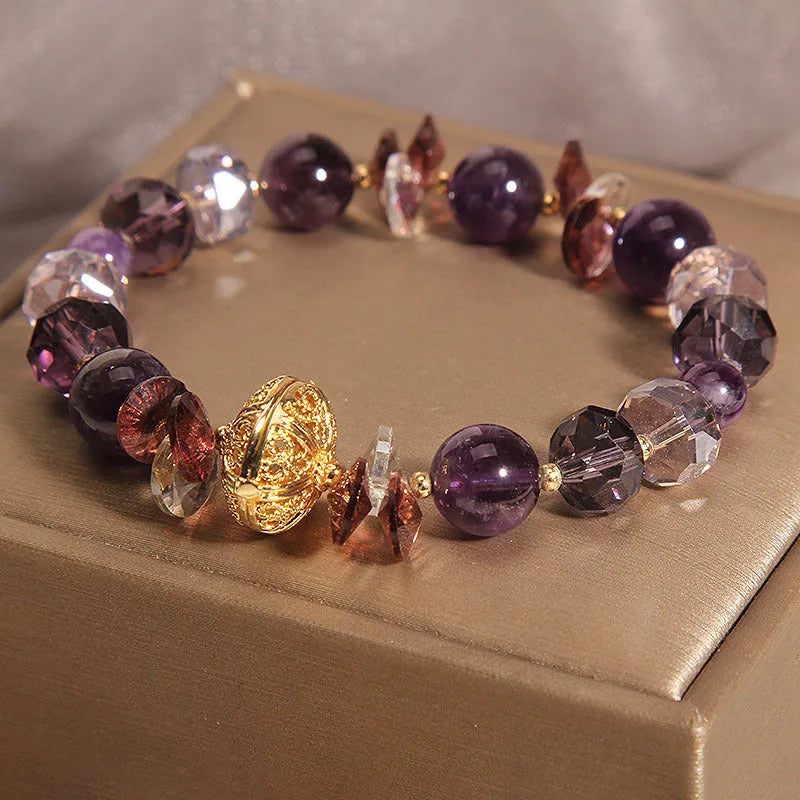 Purple crystal bracelet with pumpkin beads, wind chime motifs, and rhinestone decorations on adjustable band