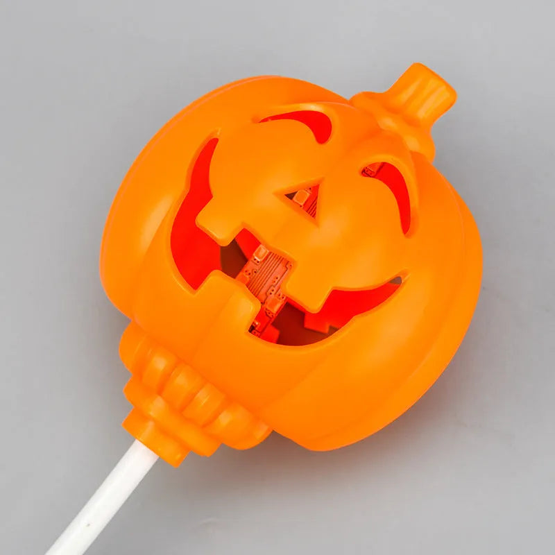 Plastic pumpkin-shaped decorative lamp with a USB cable, glowing either yellow or purple.