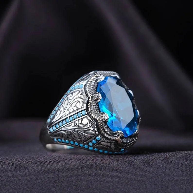 Geometric antique silver alloy couple ring with a blue zircon stone in a Grandmother Diamond setting.