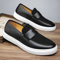 Black men's casual slip-on shoes with tassel detail and round toe on a gommino rubber sole
