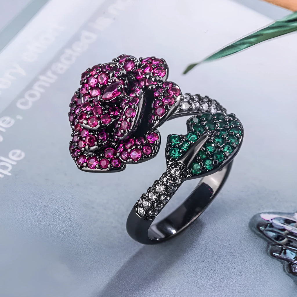 Geometric black gold ring with red simulated corundum centrepiece in flower design