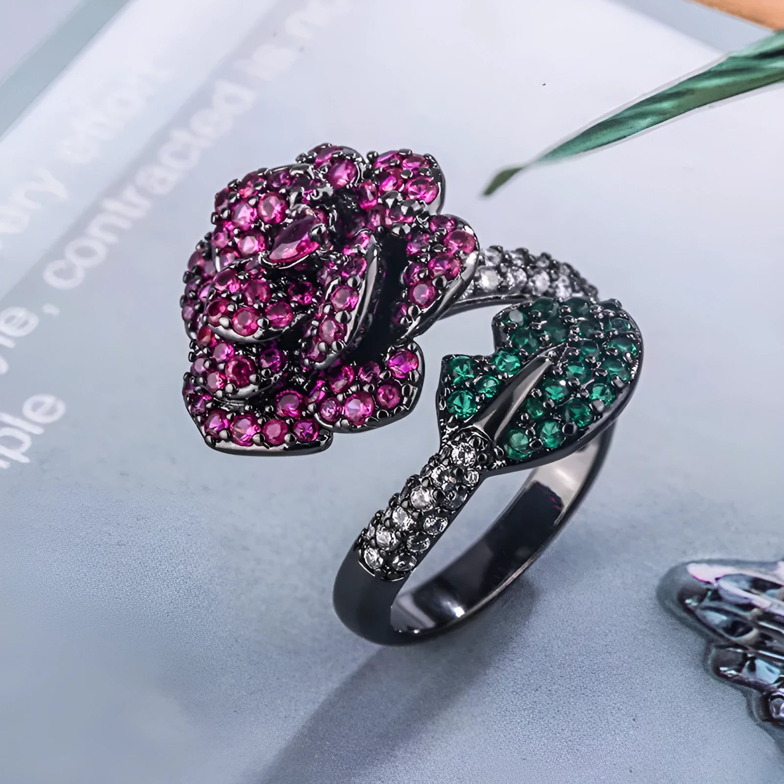 Geometric black gold ring with red simulated corundum centrepiece in flower design