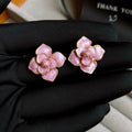 Gold plated purple flower stud earrings with copper base and fresh floral style on silver needle