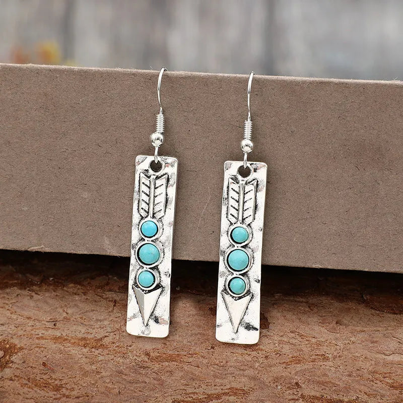 Silver geometric retro earrings with inlaid turquoise detail on zinc alloy