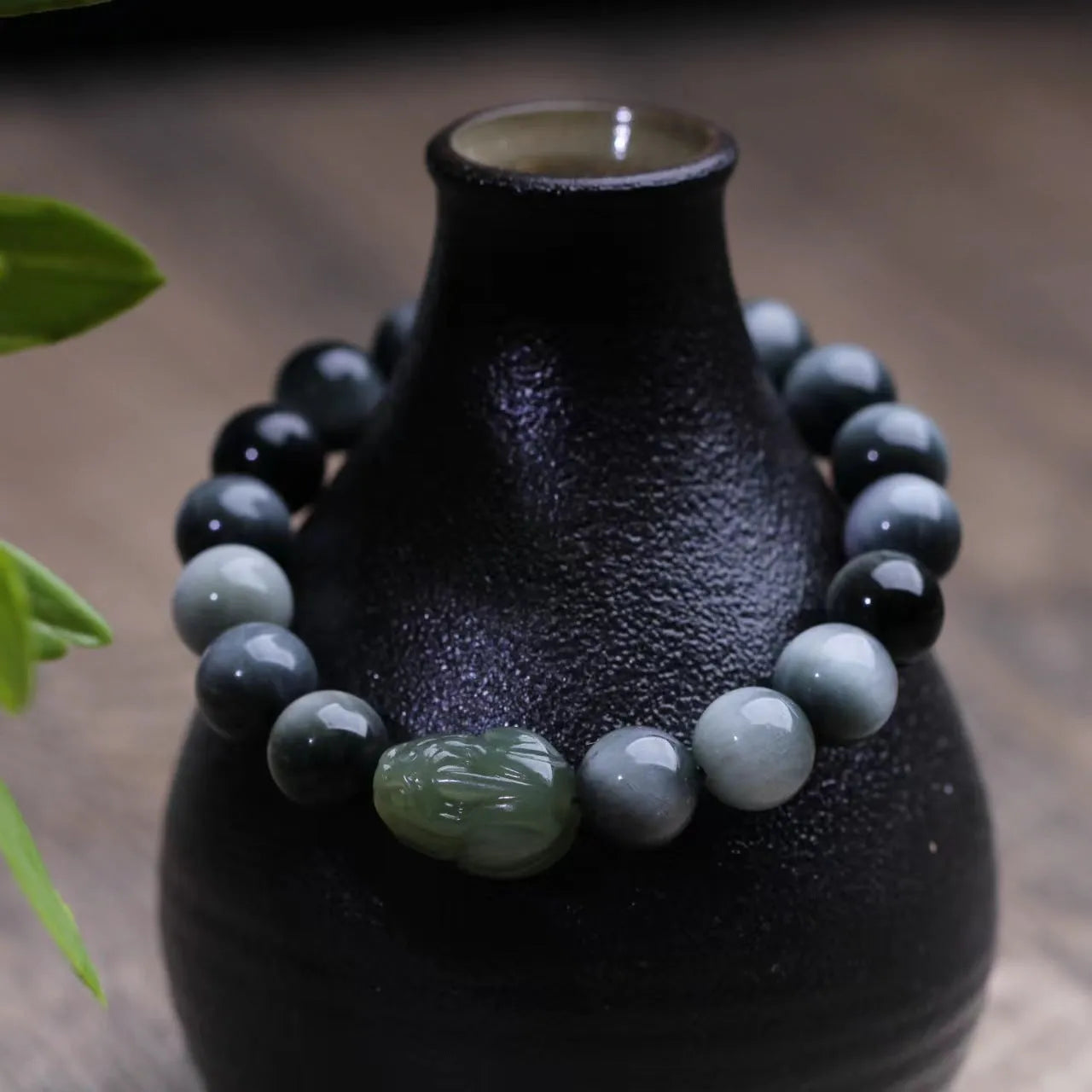 10mm Eagle Eye Stone bead bracelet with a natural Hetian Jade Clear Water Pixiu charm on a black cord.