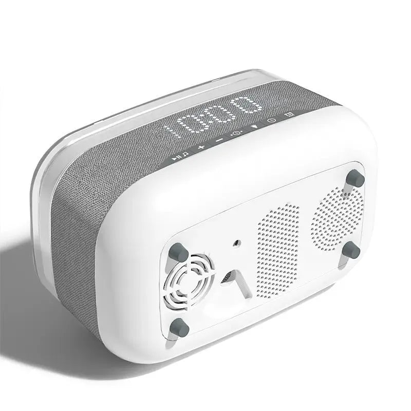 White multifunctional alarm clock unit with Bluetooth speaker and wireless charging pad.