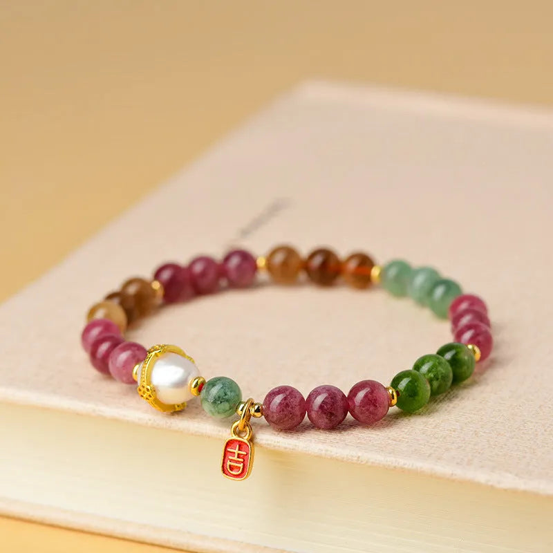 Geometric chalcedony crystal bracelet with 6.5mm beads on a wrist.