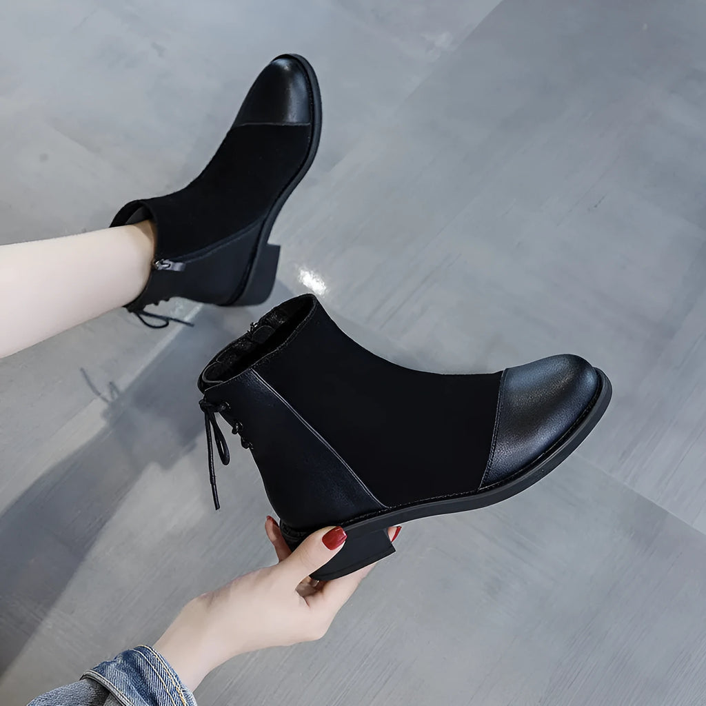 Black women's knee-high Martin boots with side zip, round toe, and chunky heel on a non-slip rubber sole.