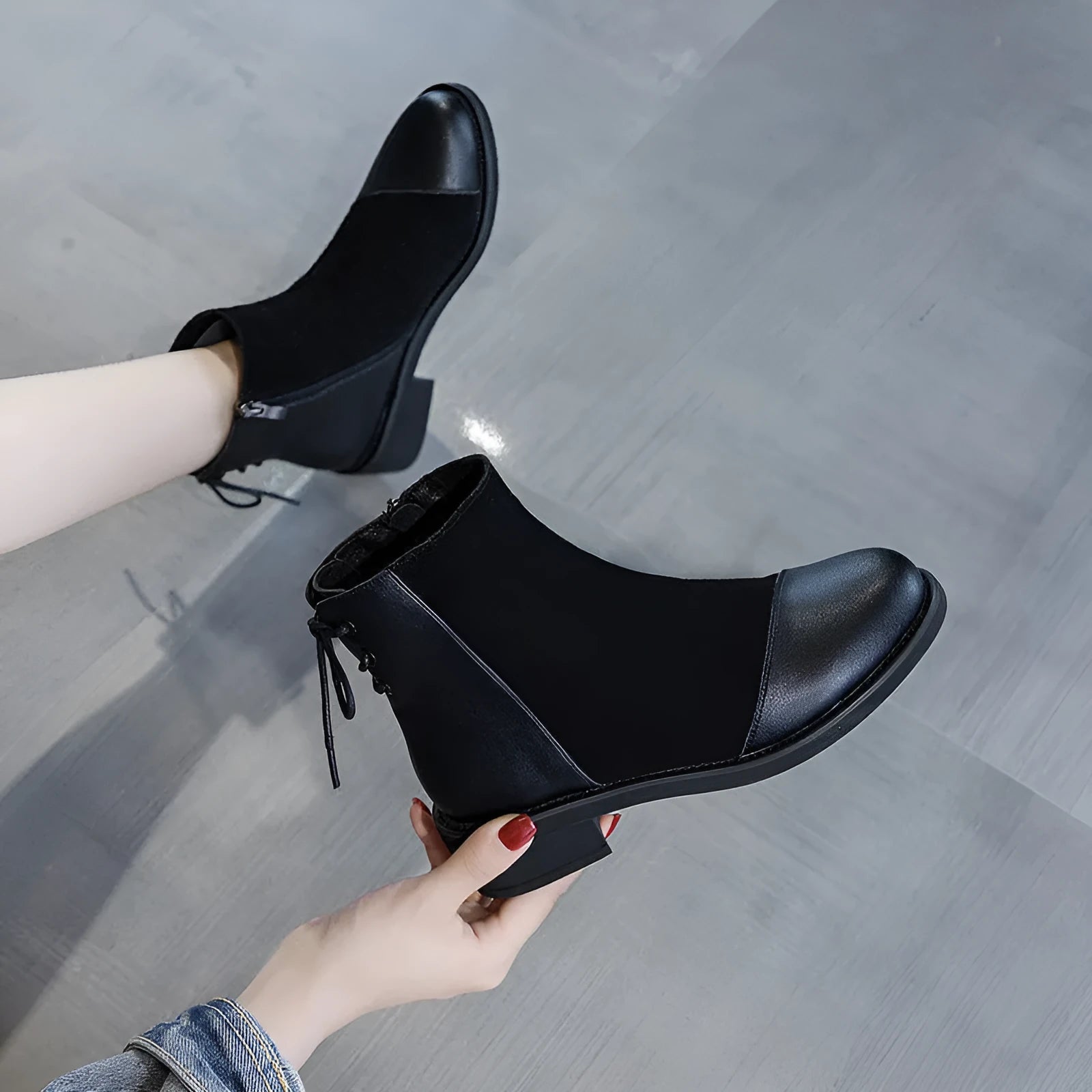 Black women's knee-high Martin boots with side zip, round toe, and chunky heel on a non-slip rubber sole.