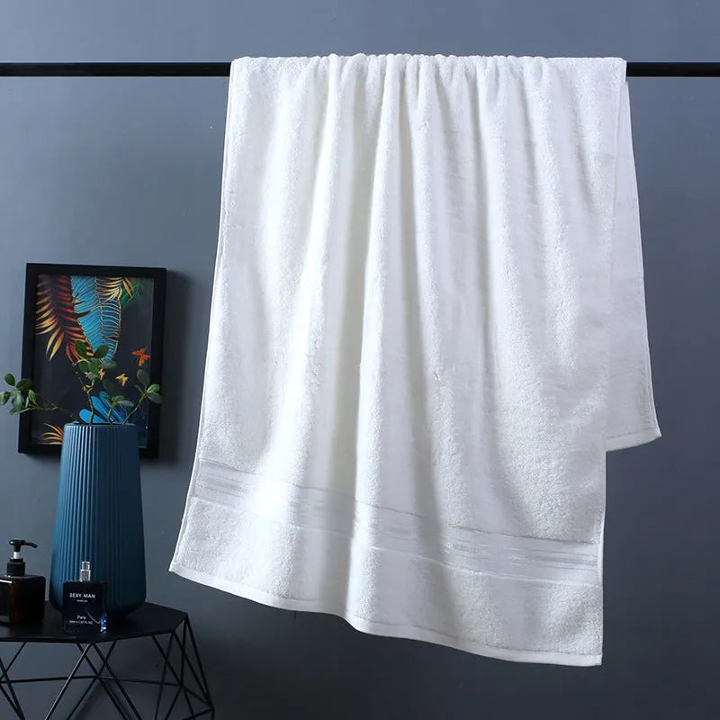Three-piece pure cotton towel set in floral colours showing bath towel, towel, and small square scarf