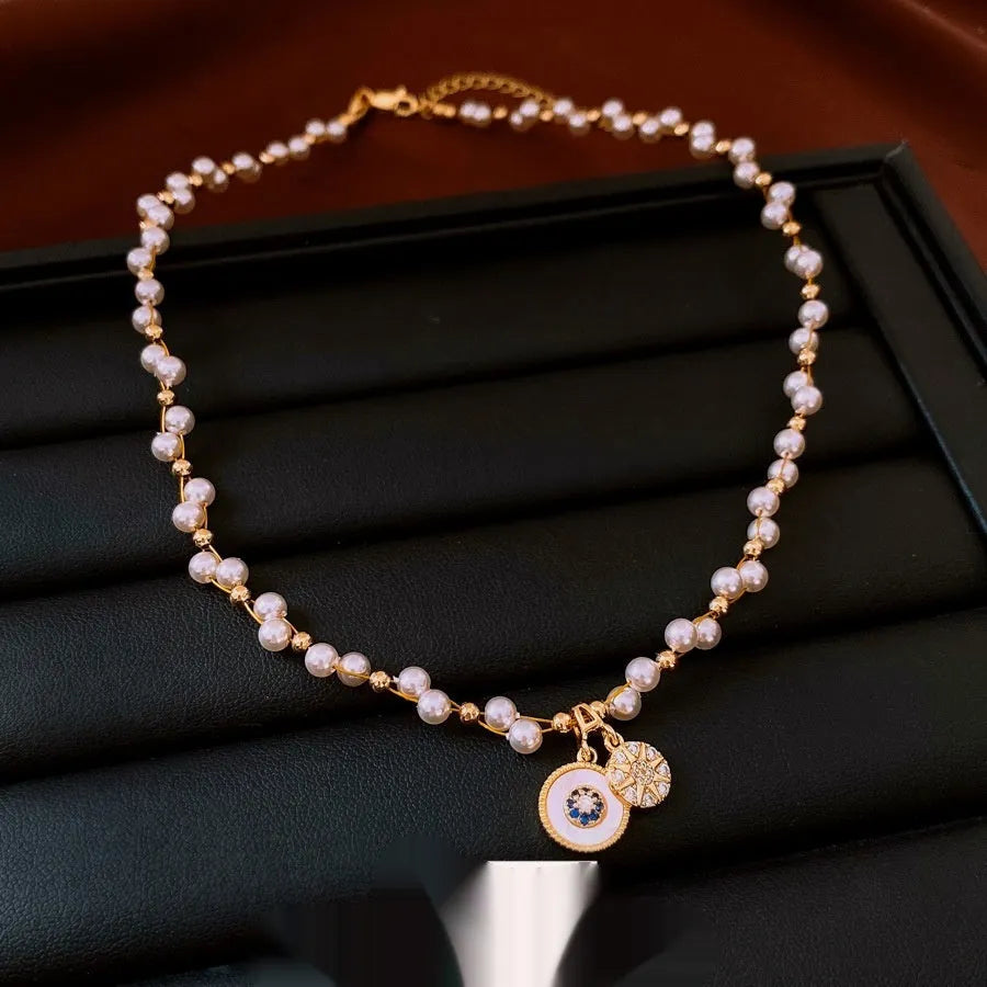 Gold electroplated necklace with round imitation pearl pendant and zircon accents on 41-50cm clavicle chain