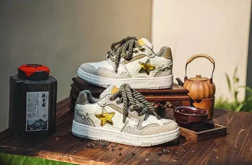Green star print low-top casual sneakers with a lace-up front and thick rubber sole.
