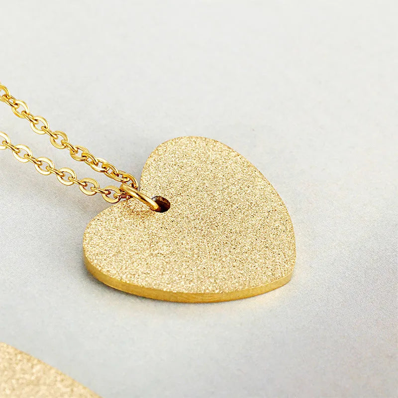Geometric titanium steel pendant necklace with a heart-shaped neckline design in a metallic finish.