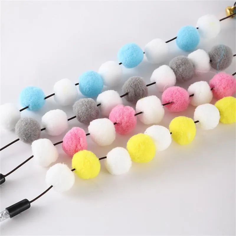 A 31cm long cat teaser toy stick with a colourful pompon, feathers, and a bell.