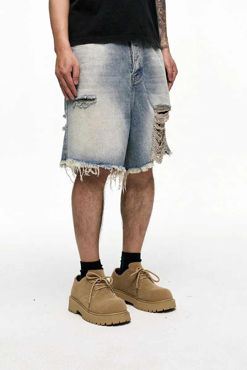 Light blue men's baggy denim shorts with a wide leg cut and mid waist on a plain background