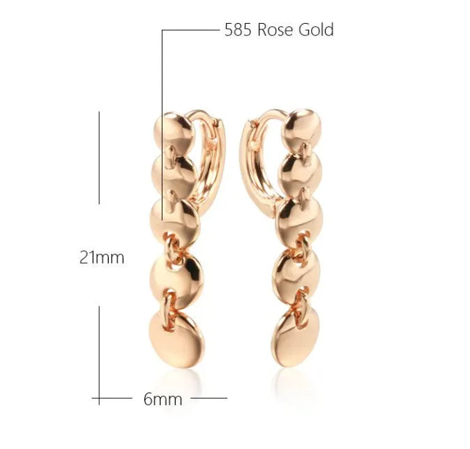 Gold-coloured retro woven round copper earrings showing textured circle design.