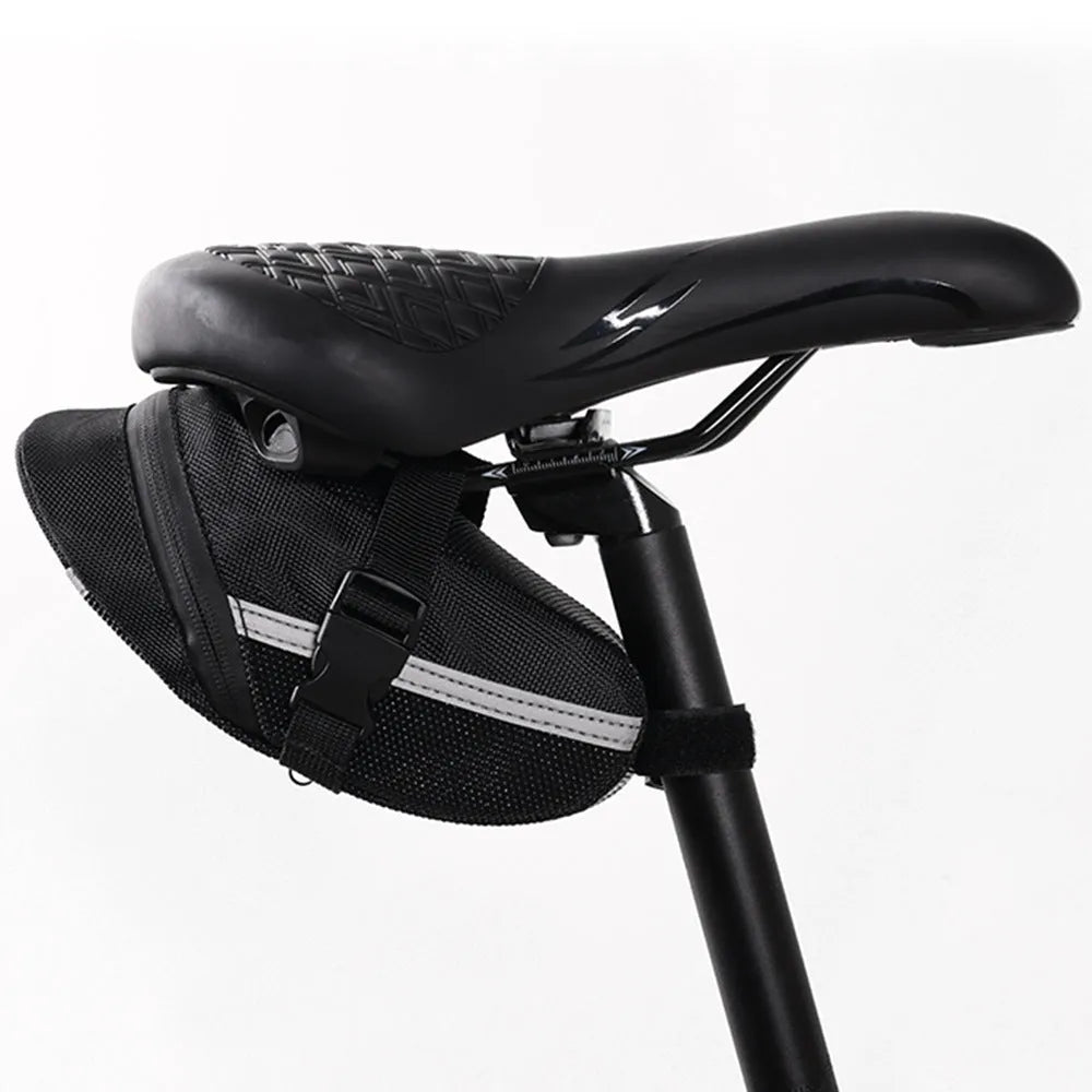 Black cycling tail bag mounted on mountain bike saddle with quick release fixture