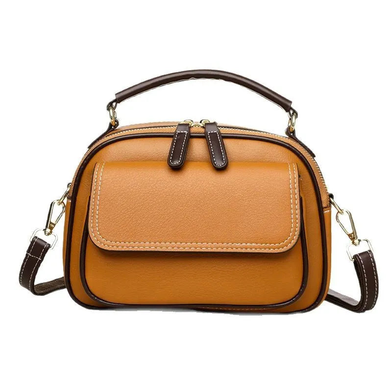 Women's black PU cross-body shoulder bag showing square shape and double connector straps