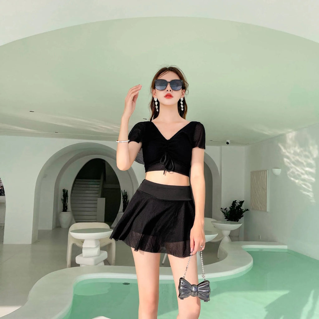 Women's two-piece swimwear set with matching top and skirt in solid colour