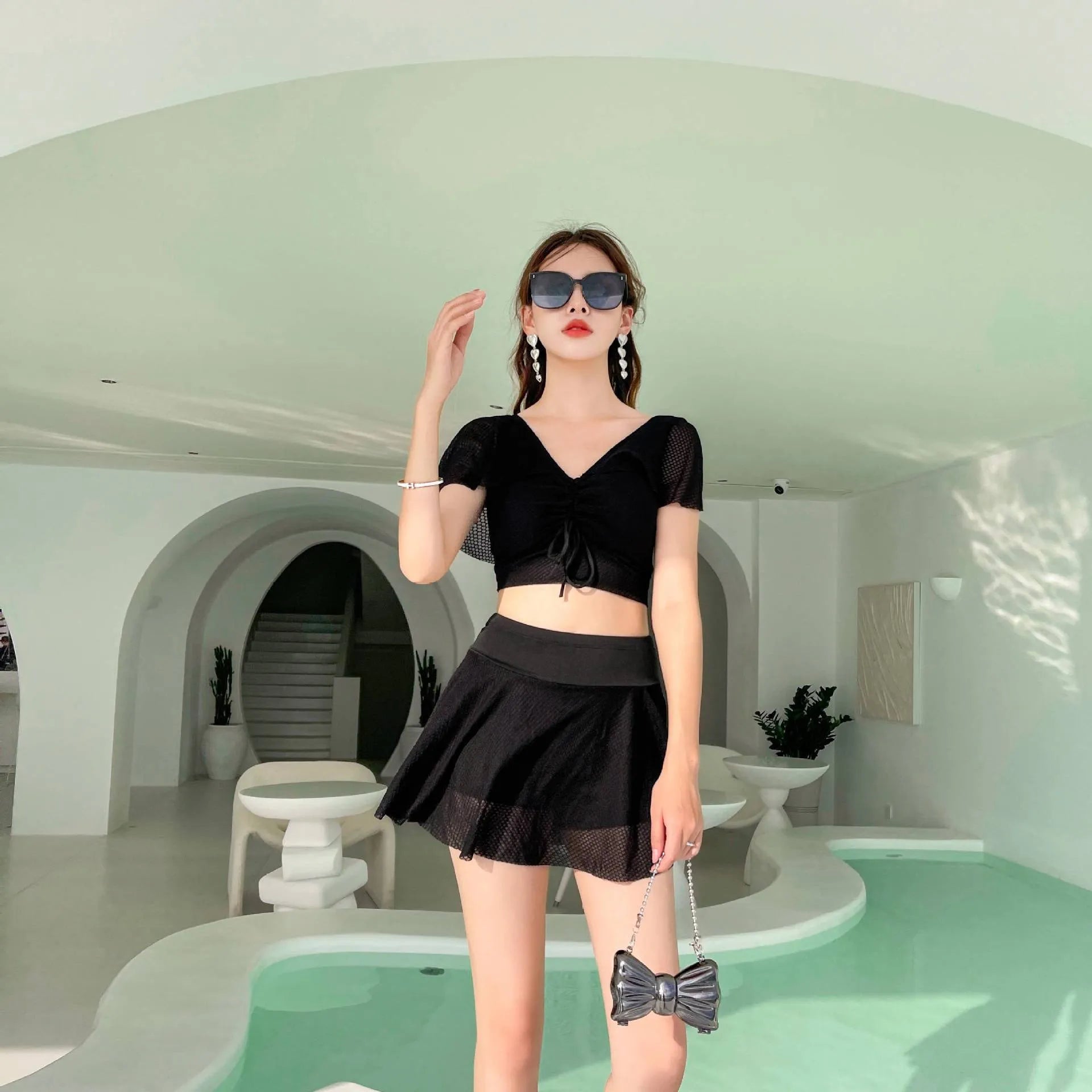 Women's two-piece swimwear set with matching top and skirt in solid colour