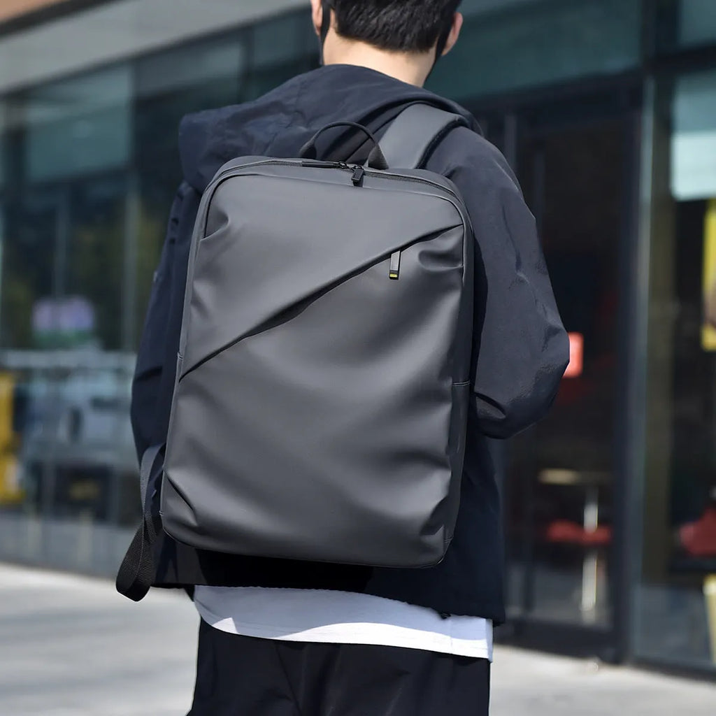 Large waterproof PU leather backpack for men in black, shown with computer compartment