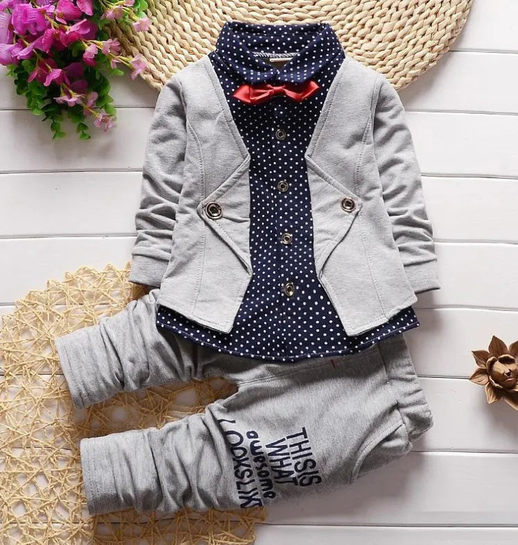 Blue children's cotton blend tracksuit set with zip-up hooded jacket and elasticated waist trousers laid flat.
