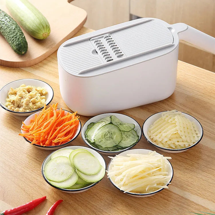 Nordic style multifunctional vegetable slicer in blue, grey, or khaki with stainless steel blades on a kitchen counter.