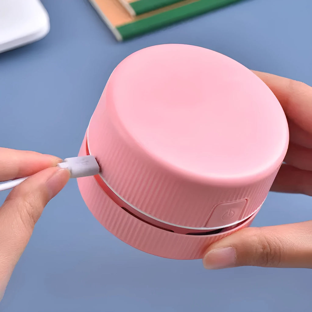 Portable mini desktop vacuum cleaner in blue and pink colour options with rechargeable battery
