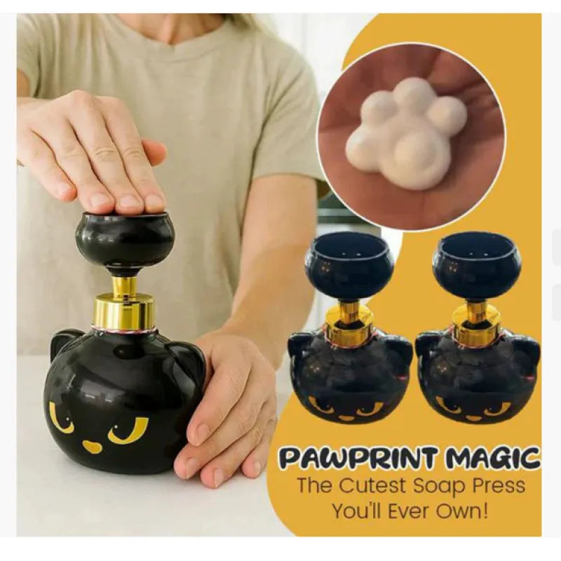 Black cartoon cat-shaped plastic foam soap dispenser on a wash basin.
