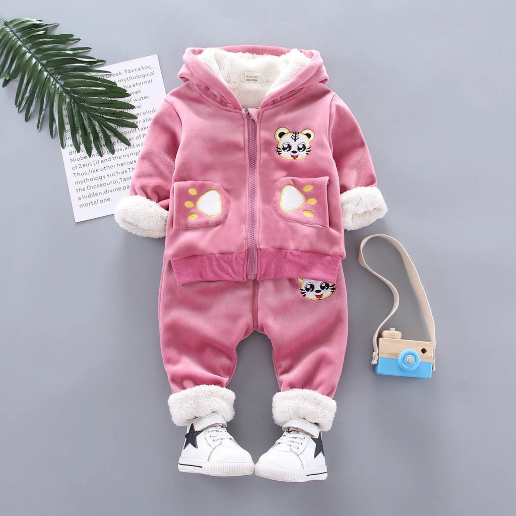Child wearing a long sleeve golden mink fleece pyjama set with cartoon animal pattern in navy blue for winter