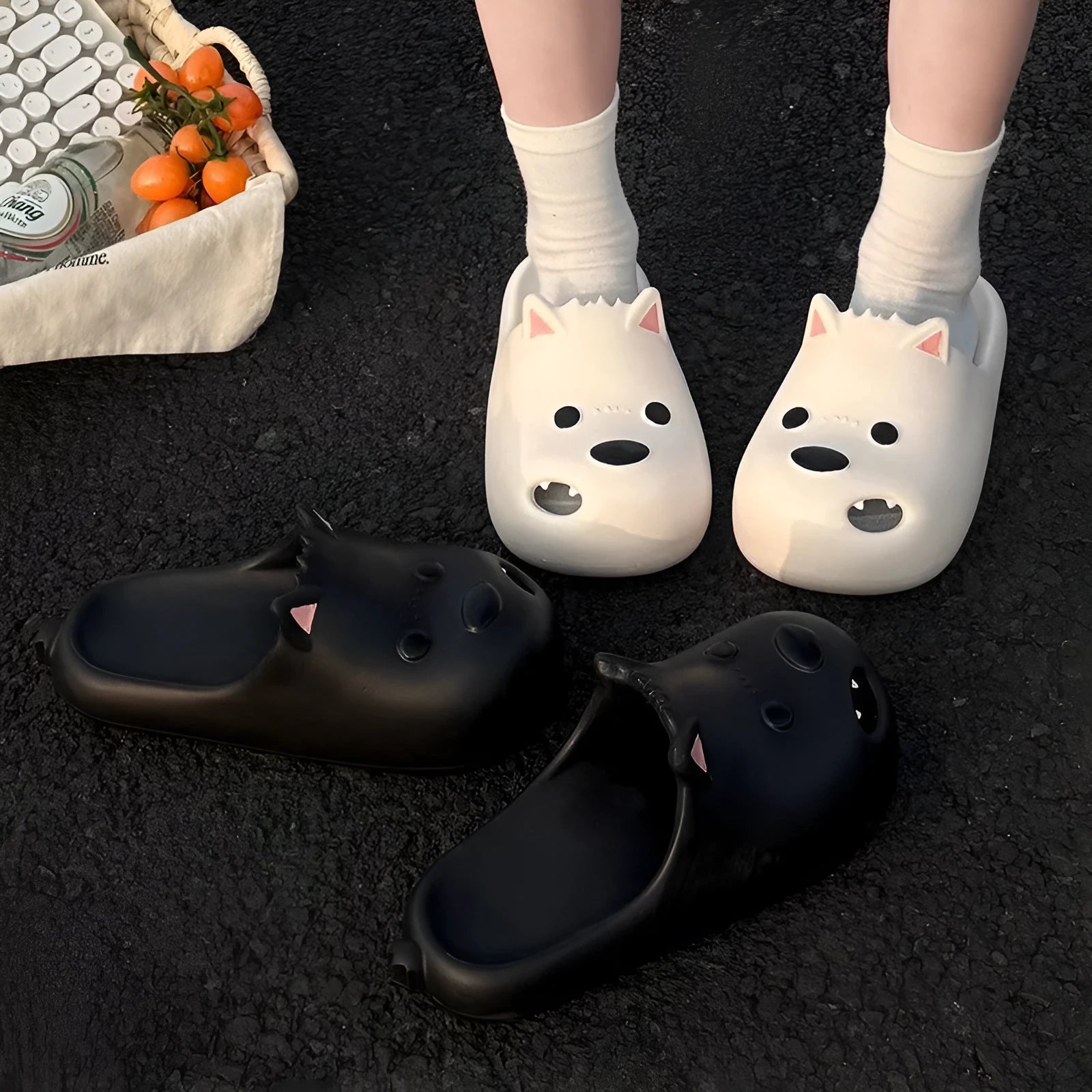 Women's black and white EVA puppy slippers with a toe-cap sandal design on a plain background.