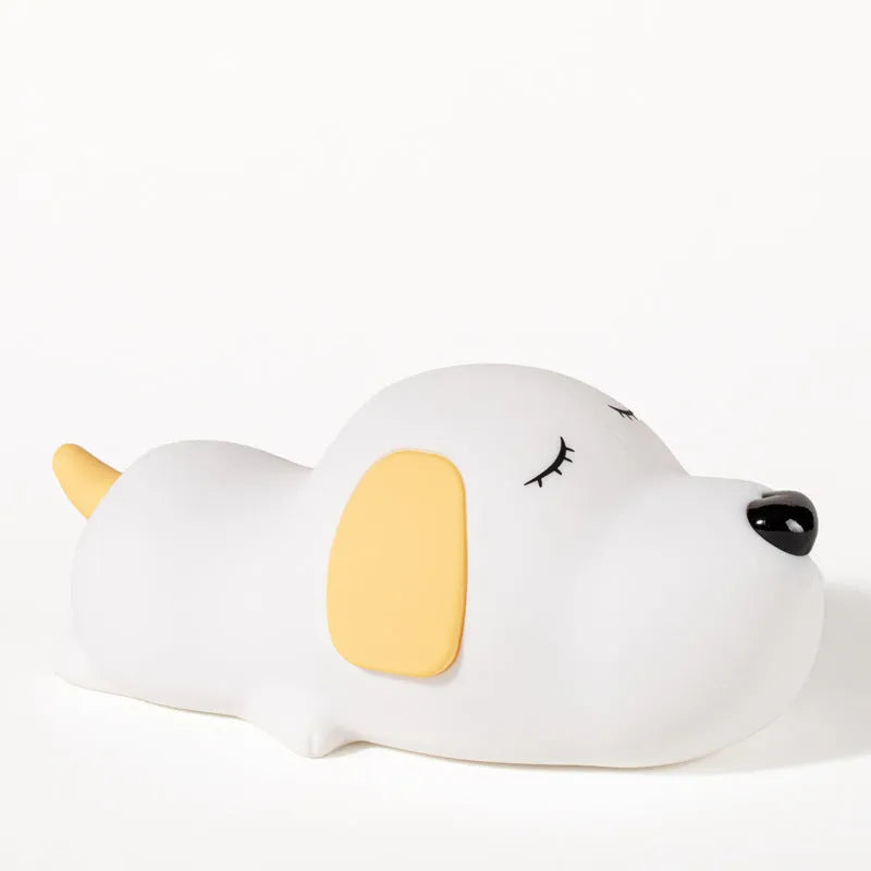 Cute two-colour silicone cartoon dog USB rechargeable night lamp on a surface.