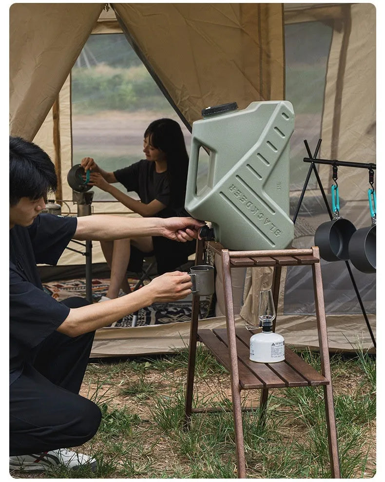 Green portable water storage tank with carry handles in backpack and snail designs