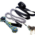 Green cotton dog tug rope toy with a teether ball end on a wooden floor.