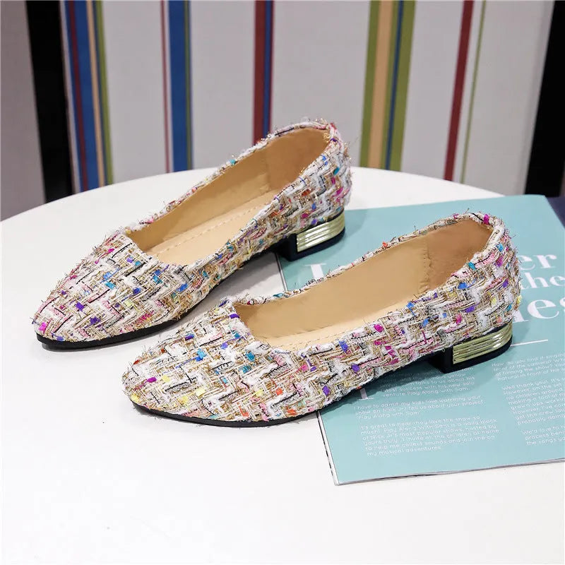 Women's black and white canvas flats with flower pattern, pointed toe, and low-cut design