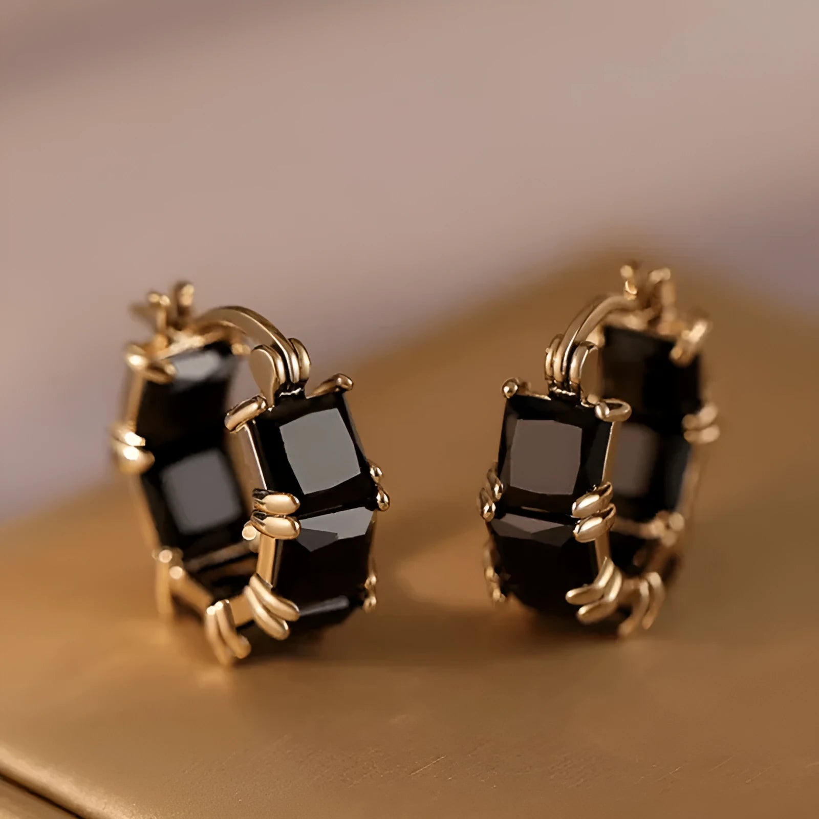 Women's geometric U-shaped earrings with round black zirconium stones and gold electroplated copper construction