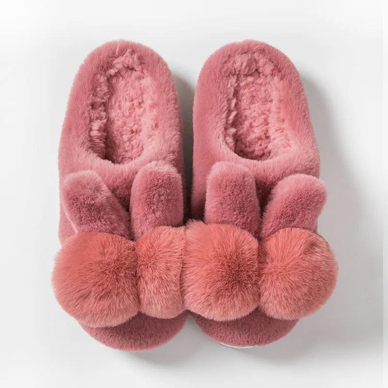 Women's rabbit fur winter slippers with high upper, floral detail, and sewn sole in creamy white.