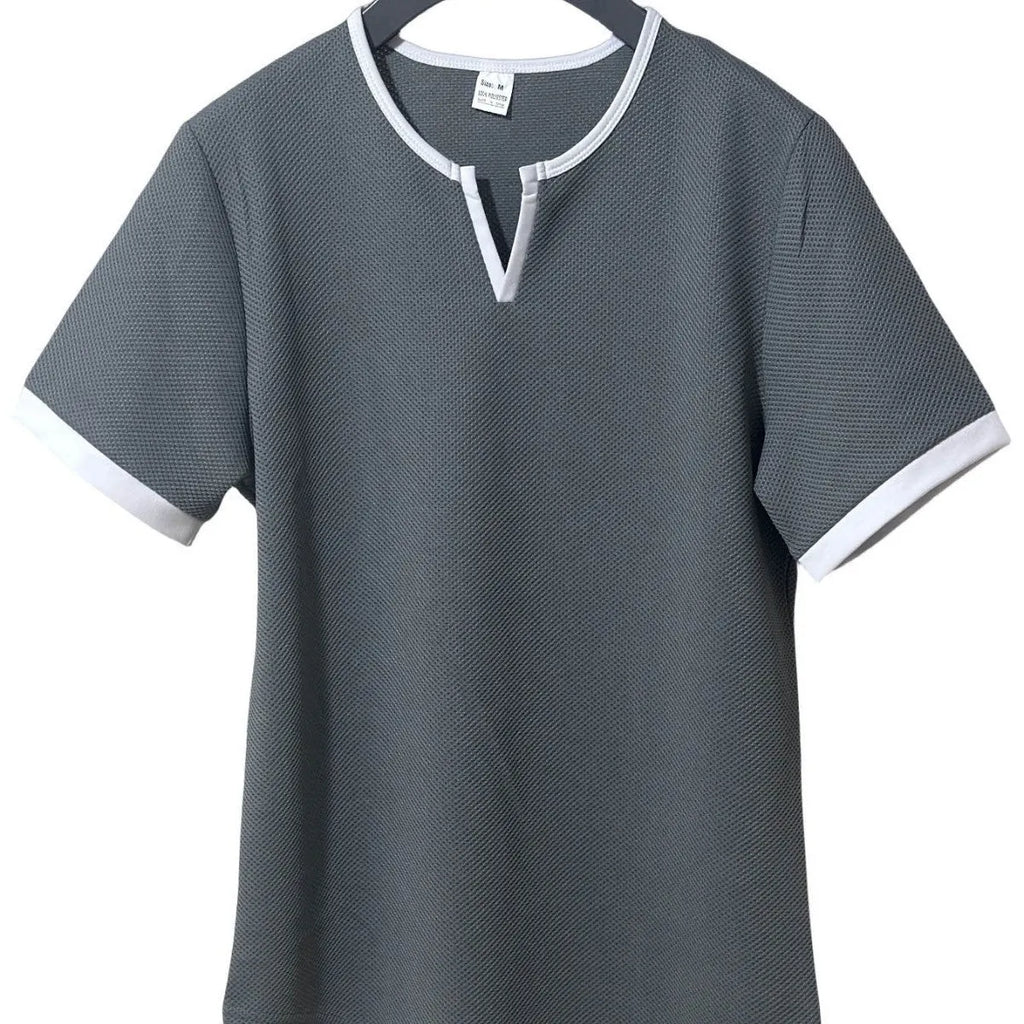 Man wearing a grey and white colour-block V-neck waffle knit short sleeve T-shirt.