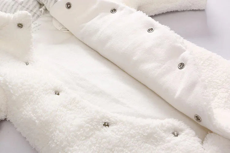 Baby wearing a white cotton padded lamb jumpsuit for winter