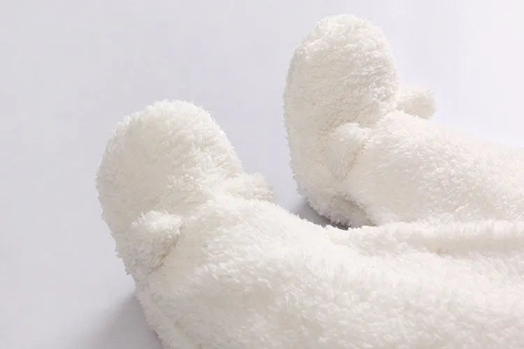 Baby wearing a white cotton padded lamb jumpsuit for winter