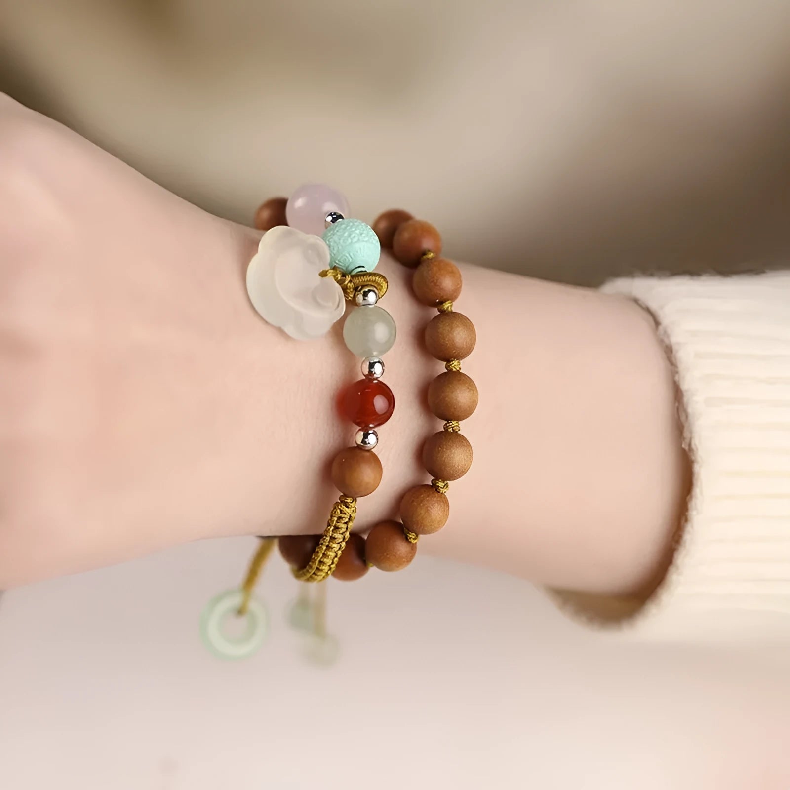 Women's hand-woven ebony double ring bracelet with traditional Ruyi motifs in Xiuyan jade or antique chalcedony