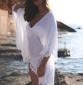 Tasselled beach coverup in cotton blend with loose fit and fringe trims on sleeves and hem