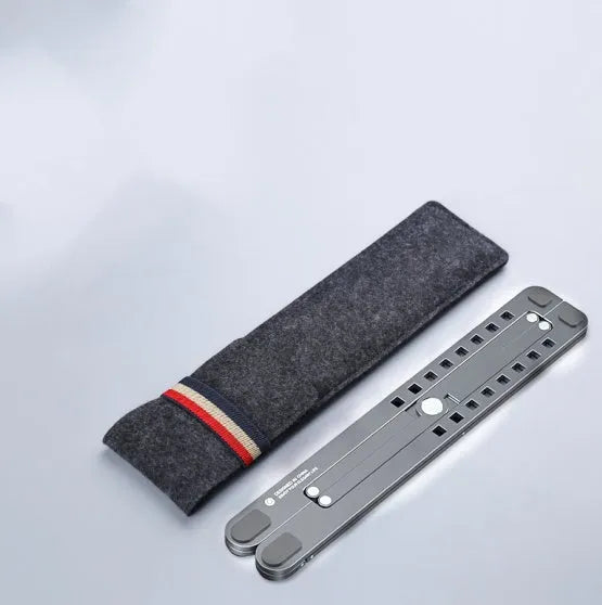 Foldable aluminium laptop stand in silver colour, shown adjusted to a height with a laptop on it