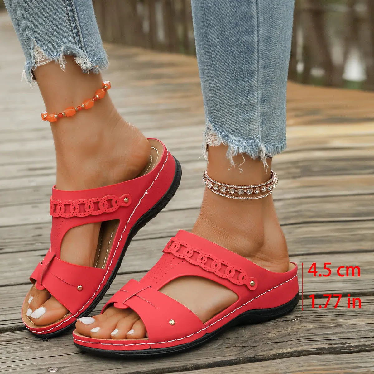 Women's blue Roman style slope heel slippers with fish mouth toe holder on a wooden floor.