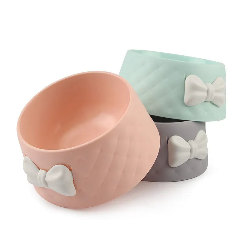 Bow shaped pet feeding bowl in PP plastic available in pink, green, and grey
