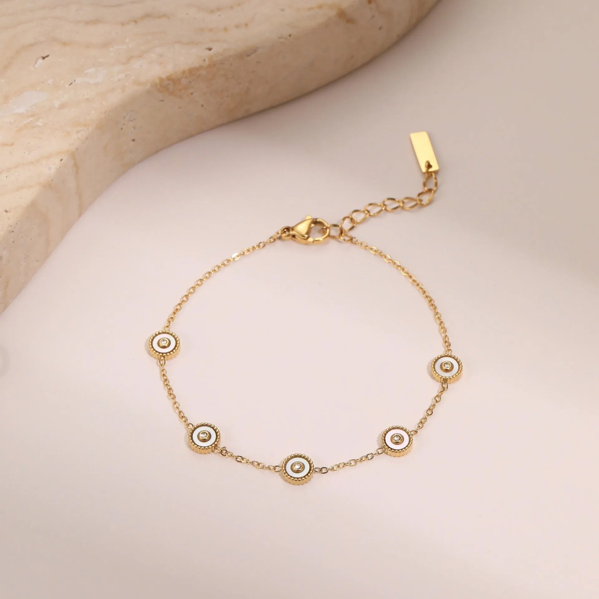 Geometric women's stainless steel bracelet with 18K gold electroplating alongside matching necklace