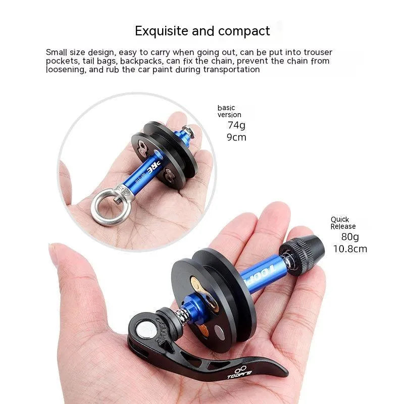 Aluminium bicycle chain holder tool for washing and tension measurement on a workbench.